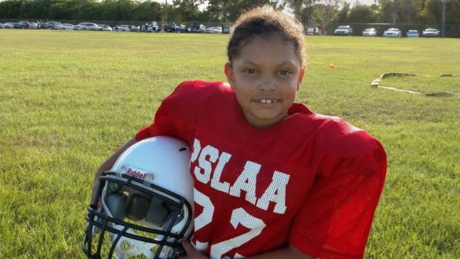 Iyana Cooper, of lower tackle (8-to-10-year-olds) team the 49ers in the Port St. Lucie Athletic Association’s youth football league, may not look different from the boys with her helmet on, but she’s the only girl playing PSLAA tackle football among the lower, middle and upper age divisions in 2014.