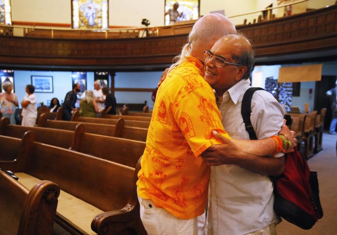 Hanuman Hoffman, left, and Arun Toke embrace after the Interfaith Prayer & Reflection Services at First Christian Church in Eugene on Monday, August 11, 2014. The monthly services began in October 2001 in response to the attacks of September 11, 2001. Since 2001, there has only been one month that has been missed. It is believed to be one of the longest-running interfaith services started in the wake of 9/11. (Andy Nelson/The Register-Guard)