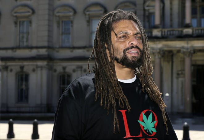 Ed Forchion, a pro-marijuana activist known as NJ Weedman, stands in front of the New Jersey Statehouse in Trenton, N.J., Sunday, April 20, 2014. Dozens of activists and community members gathered in front of Statehouse to show their support for legalizing marijuana. Sunday's rally was among many held nationwide to mark the traditional pot holiday of April 20, a day for marijuana activists to defiantly light up to protest their drug of choice being outlawed. (AP Photo/Mel Evans)