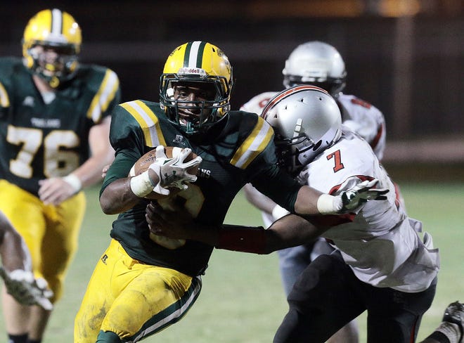 Central Lafourche running back Da'Quan Gray fights off the tackle of Clark defender during Friday's game in Mathews.