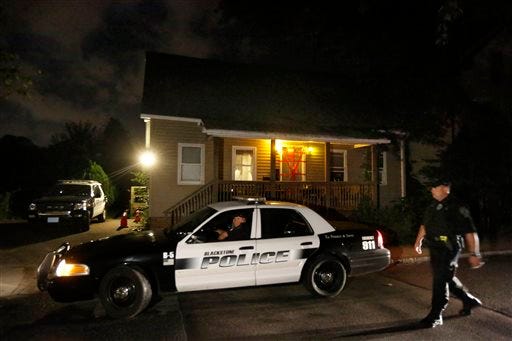 A Blackstone, Mass. police vehicle drives in front of a house where a Massachusetts prosecutor said the bodies of three infants were found, Thursday, Sept. 11, 2014, in Blackstone. Worcester County District Attorney Joseph Early Jr. said Thursday authorities don't know when or how the babies died.