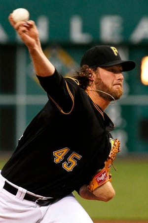 Pittsburgh Pirates starting pitcher Gerrit Cole (45) warms up before the first inning of a baseball game against the Chicago Cubs in Pittsburgh Friday, Sept. 12, 2014.