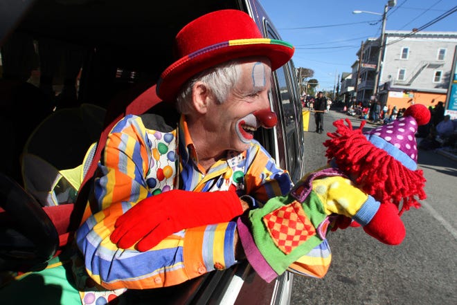 Bob Aubin, also known as Bobo the Clown, entertains the crowd from the driver's seat of his van as he makes his way down Social Street as part of the 2013 Autumnfest parade.