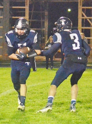 Annawan-Wethersfield’s Tanner Nichols takes the handoff from QB Tanner Litton during Friday night’s 43-0 romp over West Central.