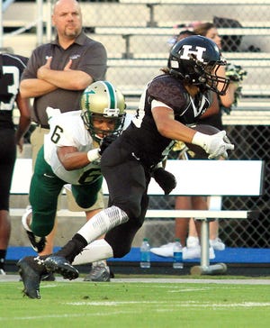 Havelock’s Dallas Frazier, right, escapes from Kinston's Marquan Harris on Thursday at Havelock High. The Rams won the contest 61-0.