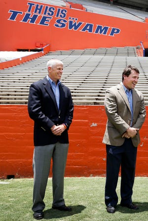 UF Athletic Director Jeremy Foley, left, and UF coach Will Muschamp share a laugh.