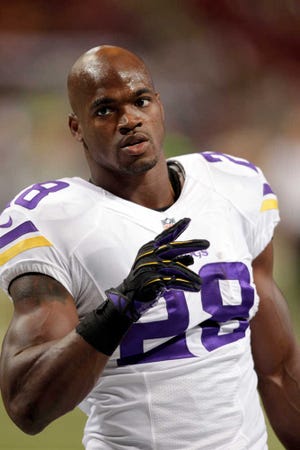 Minnesota Vikings running back Adrian Peterson warms up before the start of an NFL football game between the St. Louis Rams and the Minnesota Vikings Sunday, Sept. 7, 2014, in St. Louis. (AP Photo/Tom Gannam)