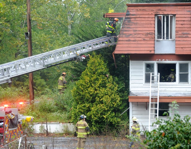 Stroud Township firefighters work at the scene of a fire at the shuttered Penn Hills resort in Analomink on Saturday, September 13, 2014. The fire reportedly started in a mattress on the second floor and appeared to be intentionally set. The state police fire marshal was summoned to the scene to investigate.