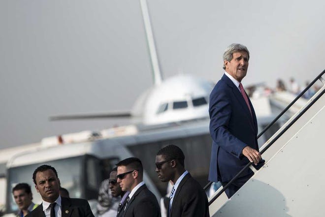 Brendan Smialowski/The Associated PressU.S. Secretary of State John Kerry boards his plane at Cairo International Airport on Saturday as he leaves the city.
