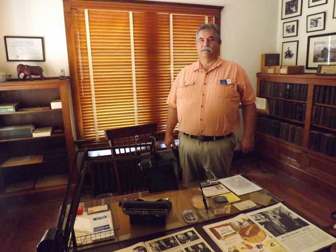 Ken Wilk, site administrator at Red Rocks State Historic Site in Emporia, stands next to William Allen White's desk, which is on display with other White artifacts and memorabilia. White campaigned against the Ku Klux Klan in 1924, when he felt the group was making inroads into Kansas.