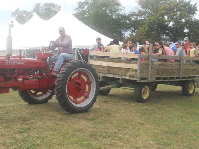 People head off on a hay ride at the Pardon Gray Preserve, where Tiverton held A Country Day at Pardon Gray, the annual rural festival featuring music, food and fun for families.
