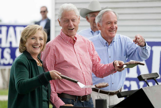 Former Sec. of State Hillary Rodham Clinton, former President Bill Clinton and U.S. Sen. Tom Harkin work the grill during Harkin's annual fundraising Steak Fry, Sunday, Sept. 14, 2014, in Indianola, Iowa. (AP Photo/Charlie Neibergall)