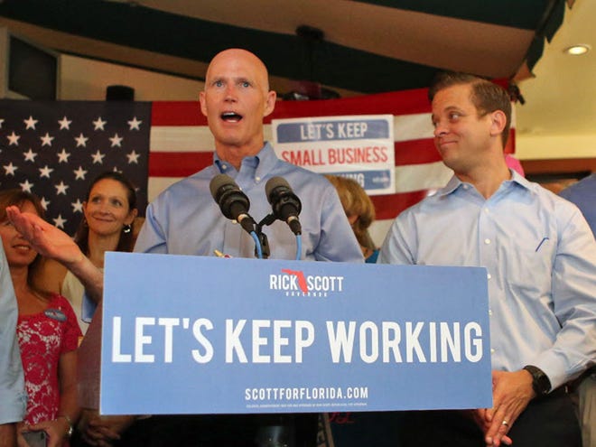 Gov. Rick Scott speaks at a support rally, along with New Jersey Gov. Chris Christie on Friday, Sept. 12 in Panama City Beach, Fla. Christie is helping Scott campaign in his tight race with Republican-turned-Democrat former Gov. Charlie Crist.