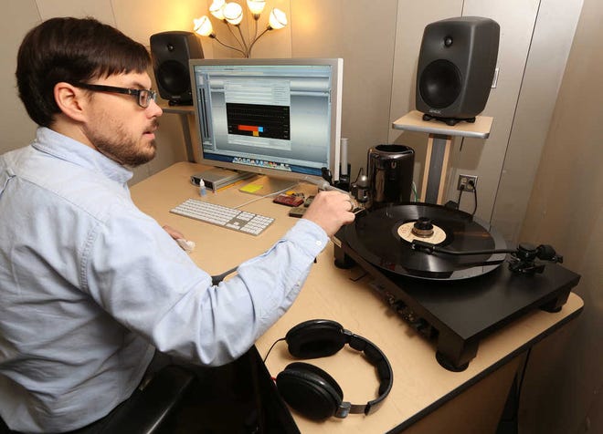 ADVANCE FOR MONDAY SEPT. 15 AND THEREAFTER - In a Thursday, Sept, 4, 2014 photo, Stephen Bolech, A/V digitization specialist at Baylor Universtiy's digital library collection, uses a turntable connected to an analog-to-digital converter, to capture a recording, in Waco, Texas. Recordings of sermons by Rev. George W. Truett, the namesake of Baylor's seminary, are being archived into a digital collection. ( AP Photo/Waco Tribune Herald, Rod Aydelotte)