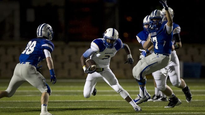 Pflugerville running back Darius Jones tries to get past Georgetown defensive back Brodie Sachs, left, in the second quarter at Birkelbach Field in Georgetown on Friday September 12, 2014. JAY JANNER / AMERICAN-STATESMAN