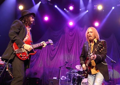 (file) Mike Campbell of the Heartbreakers (left) and Tom Petty jam during their Hypnotic Eye Tour in 2014 at the Wells Fargo Center.