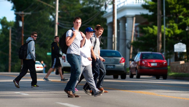 University of Missouri students cross College Avenue on Tuesday morning. The Columbia City Council on Monday approved pedestrian safety improvements for a stretch of College where pedestrians frequently cross the road.