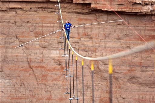 In this June 23, 2013 file photo provided by the Discovery Channel, aerialist Nik Wallenda walks a 2-inch-thick steel cable taking him a quarter mile over the Little Colorado River Gorge, Ariz. On Tuesday, Sept. 16, 2014, Wallenda said that his next tightrope walk will be more than 50 stories high from one high-rise building to another over the Chicago River. Wallenda will attempt the night-time feat without a net or harness and it will be broadcast live on the Discovery Channel on Nov. 2. (AP Photos/Discovery Channel, Tiffany Brown, File)