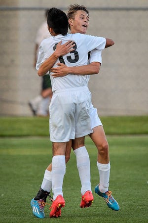 Topeka High's Chase Hochard, back, celebrates with Alan Pacheco-Morales after Hochard scored Tuesday.