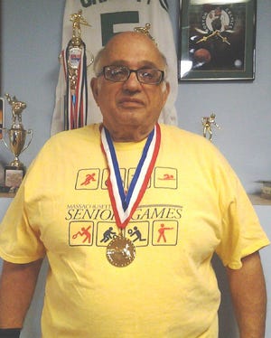 Richard Ganem displays the gold medal he won in the Massachusetts Senior Games.

Courtesy photo
