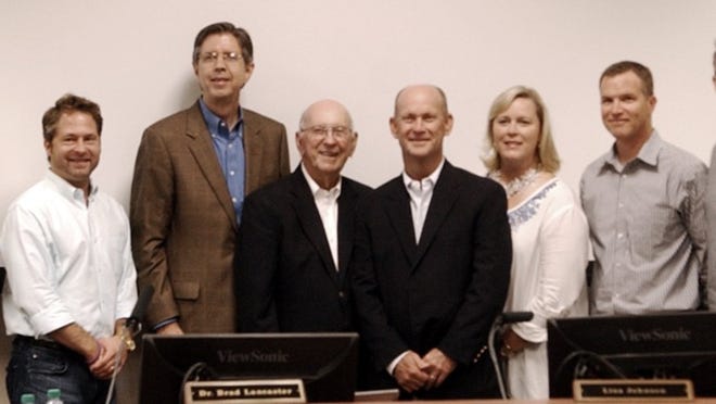 Johnny Fields (fourth from left) and Chuck Fields (fifth from left) are recognized at the Sept. 16 school board meeting as the architects of the Hudson Bend Middle School expansion project, which recieved two criteria awards for planning and design from the Texas Society of Architects in conjunction with the Texas Association of School Administrators and the Texas Association of School boards. They are joined by (from left) boardmember Dawn Buckingham, board president Jason Buddin, Superintendent Brad Lancaster, board vice president Lisa Johnson and boardmembers William Beard and Alex Alexander.RACHEL RICE / LAKE TRAVIS VIEW9/16/2014LAKE TRAVIS SCHOOL DISTRICT ADMINISTRATION BUILDING