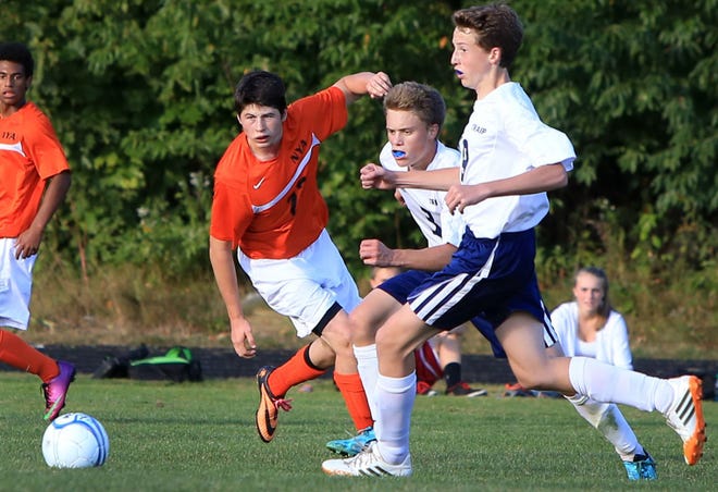 Ioanna Raptis/Portsmouth Herald photo

North Yarmouth Academy's Bobby Murray, left, and Traip Academy's Henry Driscoll, center, and James Stevens, right, chase after the ball during the Western Maine Class C boys soccer game in Kittery on Tuesday.
