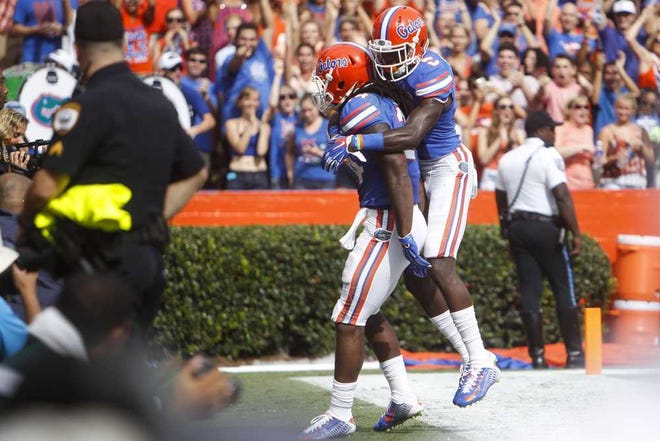 Eve Edelheit Tampa Bay Times Florida running back Matt Jones and receiver Ahmad Fulwood (back) celebrate after Jones scored a touchdown against Eastern Michigan on Sept. 6 in Gainesville.
