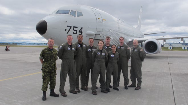 VP-30 aircrew stand with one of their Canadian Armed Forces liaisons. (From left) Warrant Officer Sean Organ of 5 wing operations, Lt. Brian Morgan, Lt. Ron Belany, Lt. Jason Dodge, Lt. Jill Kroncke AWO1 Jarrod Post, AWO3 Rachel Korzeb, AWO1 Tymothy Waddell and Lt. Ryan Seligman.