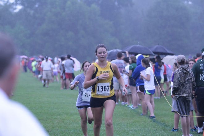 In the picture, St. Amant sophomore Madeline Lato races to the finish line. Photo by Tanya Whitney.
