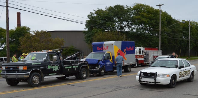 A tow truck prepares to remove a damaged Red Bull delivery truck after an accident on Carleton Road in Hillsdale. MATTHEW MANEVAL PHOTO