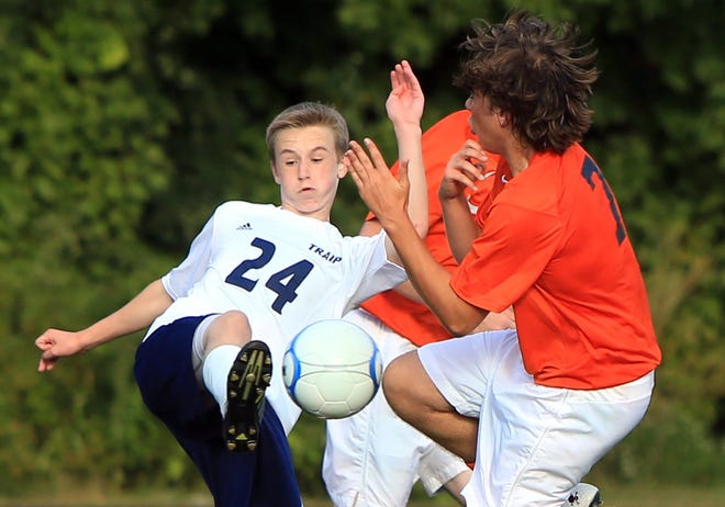Traip Academy's Andrew Davis, left, tries to kick the ball past North Yarmouth Academy's Noah Dennis during Tuesday's Western Maine Class C boys soccer game in Kittery, Maine.