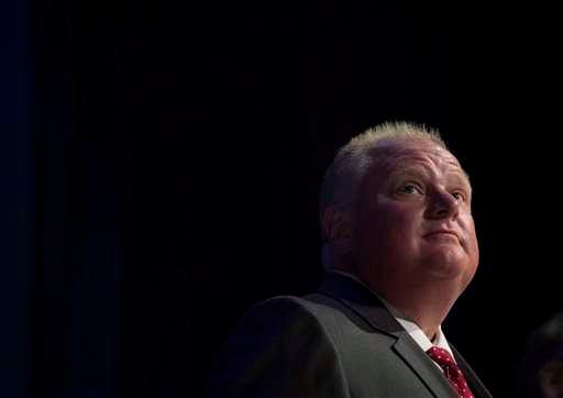 In a July 15, 2014, file photo Toronto Mayor Rob Ford pauses while participating in a mayoral debate in Toronto. Ford's doctor has confirmed the mayor has a rare form of cancer.