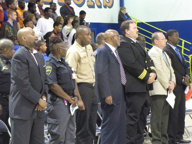 Honored guests and Job Corps students and faculty stand for the National Anthem.