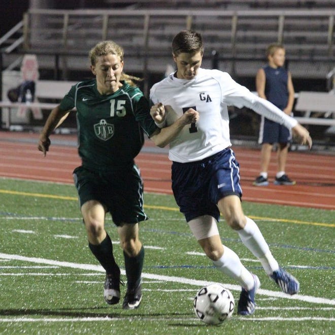 Greencastle-Antrim's Jake Kline (right) battles for position with James Buchanan's Collyn Gingrich (15) during Tuesday night's boys' varsity soccer game at Kaley Field.