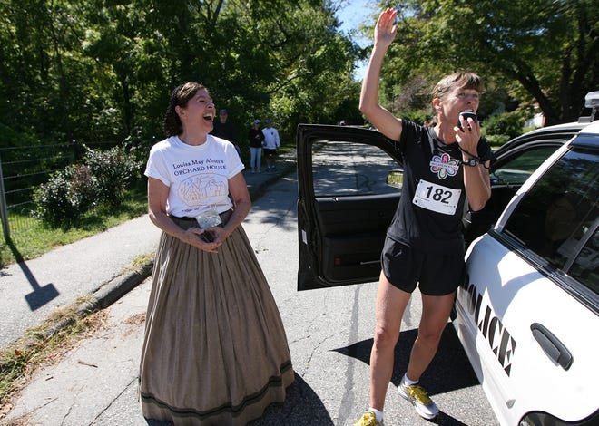 Marathoner Uta Pippig, right, Honorary Chair of the races sponsored by Louisa May Alcott's Orchard House on Sunday, talks to the runners just before the start of the races at noon. Joining in the laughter is Orchard House Executive Director Jan Turnquist. Sunday afternoon. Wicked Local Staff Photo/Ann Ringwood