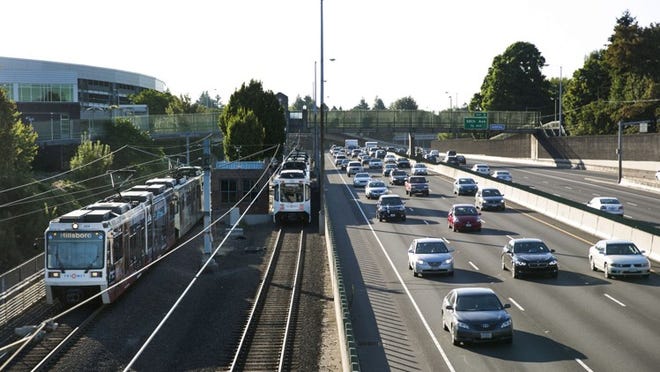 Since 1986, Portland has built 53 miles of light rail, more than seven miles of streetcar service and a commuter line, spending about $4 billion to do it. The light rail system in 2013 had about 107,000 boardings a day, about 40 times the ridership of MetroRail in Austin. Morning traffic on U.S. 84 near Cesar Chavez Boulevard moves along next to a light rail train in Portland, Ore., last week.
