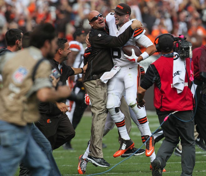 Cleveland head coach Mike Pettine, left, leaps in celebration with quarterback Brian Hoyer after time had run out during the Browns 26-24 victory over the New Orleans Saints at FirstEnergy Stadium on Sunday, Sept. 14, 2014, in Cleveland, Ohio. (Ed Suba Jr./Akron Beacon Journal/MCT)