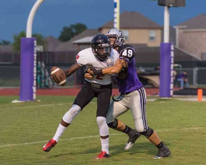 Dutchtown's Michael Tadda brings down Donaldsonville quarterback Tyler Brown for a big loss in the Griffins' 43-0 victory Friday night. Photo by Dewey Keller.