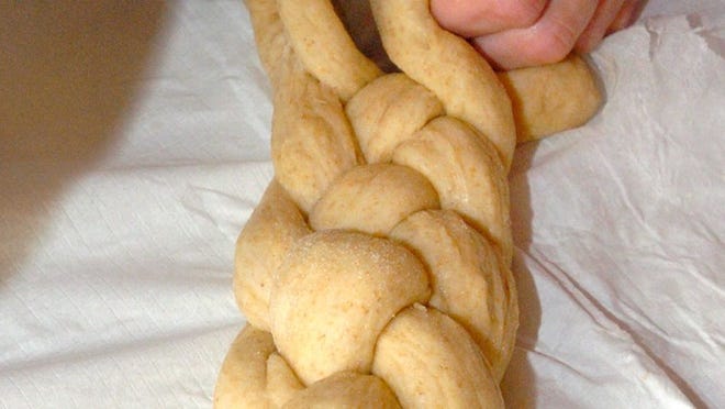 Dough is braided to make a traditional loaf of challah.