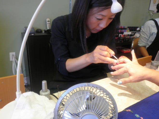 Maria Hwang, owner of Maria Nails & Spa in Burlington Township, goes to work on a customer.