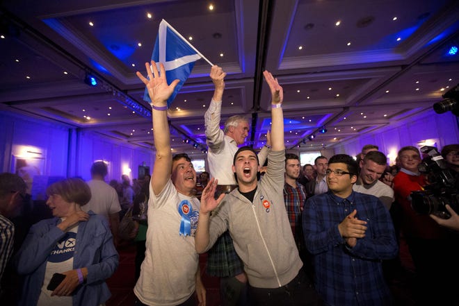 Supporters of the No campaign for the Scottish independence referendum celebrate after the final result was announced at a No campaign event at a hotel in Glasgow, Scotland, Friday, Sept. 19, 2014. Scottish voters have rejected independence and decided that Scotland will remain part of the United Kingdom. The result announced early Friday was the one favored by Britain's political leaders, who had campaigned hard in recent weeks to convince Scottish voters to stay. It dashed many Scots' hopes of breaking free and building their own nation. (AP Photo/Matt Dunham)