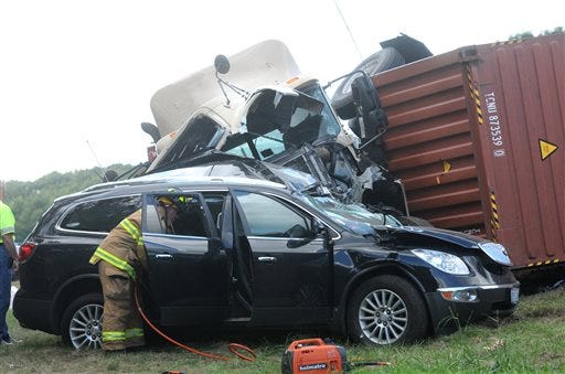 Kittery fire and police as well as Maine State Police respond to a two vehicle accident involving an overturned tractor trailer unit on I-95 Northbound Thursday, Sept. 18, 2014.