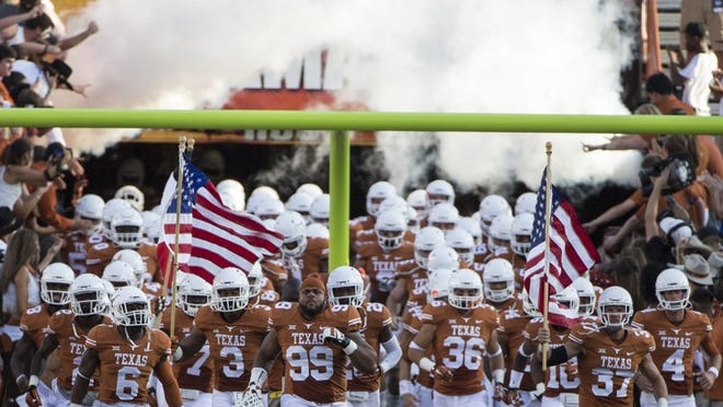 Defensive tackle Desmond Jackson (99) leads the Longhorns football team onto the field prior to the BYU game. Jackson was lost for the season, however, during last week’s loss to UCLA.