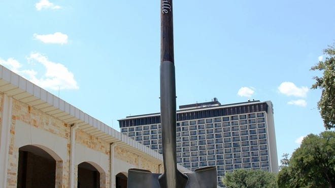 Chris Anderson designed and created the world’s largest shovel. Here he is standing next to his work, made out of recycled materials, including the telephone pole that serves as the handle. (Photo provided by Garden-Ville)