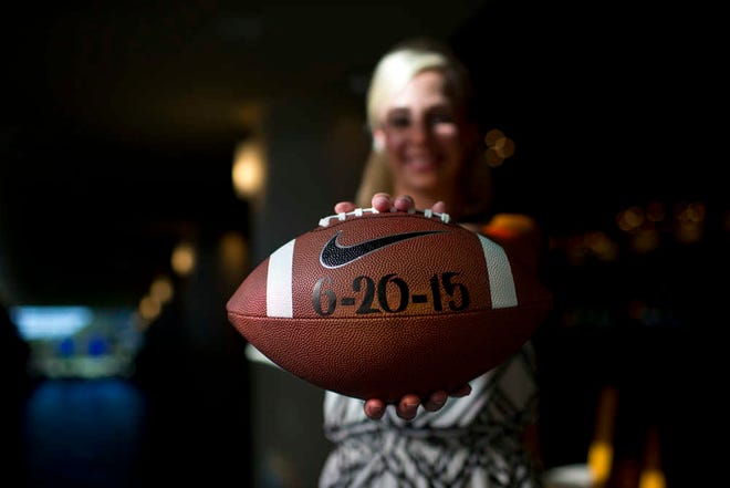 Emily Younker poses for a portrait on Thursday, Aug 28, 2014, in Montgomery, Ala. She isn't getting married until next year but she's already made sure the date doesn't conflict with college football. (AP Photo/Brynn Anderson)