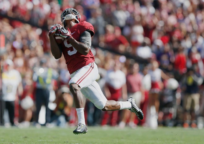 Alabama wide receiver Amari Cooper (9) catches the ball and runs for a touchdown against Florida in the first half of an NCAA college football game on Saturday in Tuscaloosa, Ala.