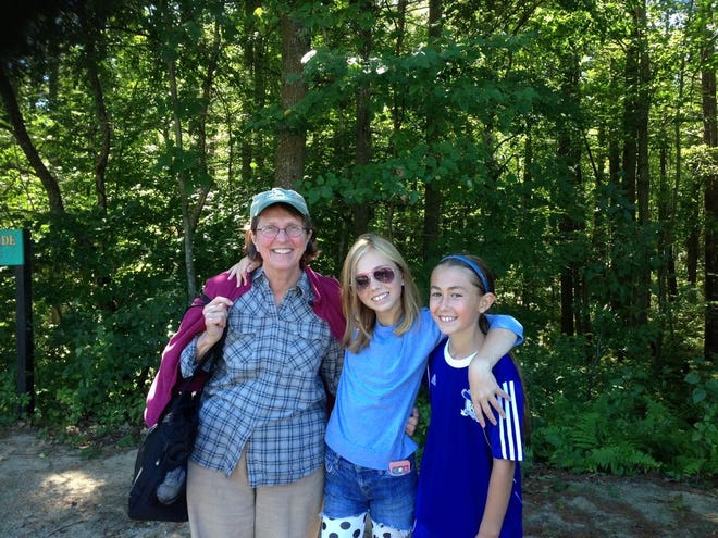 A grandmother in Maine joyfully reconnects with her two granddaughters after a summer vacation's separation.