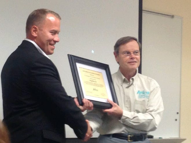 Sig Sauer Director of Supply Chain David Connors accepts the Company of the Year award from APICS Granite State chapter president Dave Turbide at an award ceremony held recently at Pease International Tradeport in Portsmouth.

COURTESY PHOTO