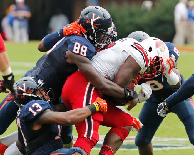 Louisville running back Dominique Brown (10)  is stopped by Virginia linebacker Max Valles (88) and linebacker Daquan Romero (13) during the first half of an NCAA college football game in Charlottesville, Va., Saturday, Sept. 13, 2014. (AP Photo/Steve Helber)