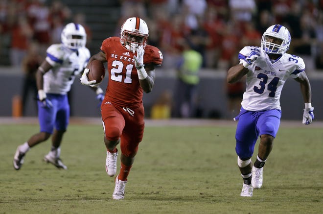 North Carolina State's Matt Dayes (21) runs for a touchdown as Presbyterian's Breyon Williams (34) chases during the second half of an NCAA college football game in Raleigh, N.C., Saturday, Sept. 20, 2014. North Carolina State won 42-0.